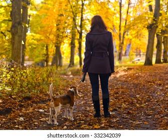 Woman With Dog Walking In The Park