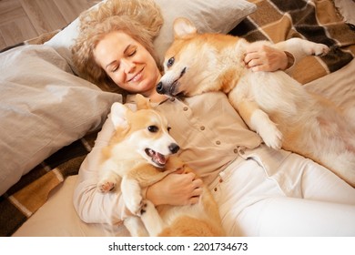 Woman And Dogs Lie On Bed, Family, Smiling. Relax, Spend Time Together, Enjoy And Have Fun. Lifestyle, Everyday Life.