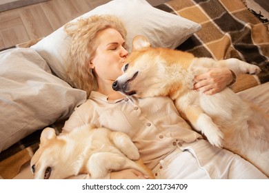 Woman And Dogs Lie On Bed, Family, Smiling. Relax, Spend Time Together, Enjoy And Have Fun. Lifestyle, Everyday Life. Love