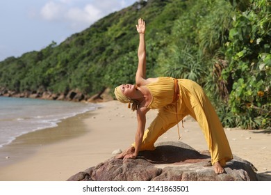  Woman Doing Ashtanga Vinyasa Yoga Asana Utthita Trikonasana - Extended Triangle Pose Outdoors 