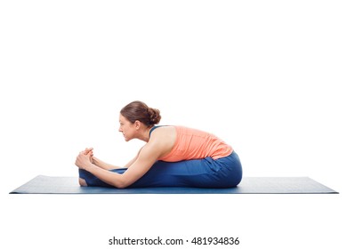 Woman doing Ashtanga Vinyasa Yoga asana Paschimottanasana - seated forward bend pose isolated on white background