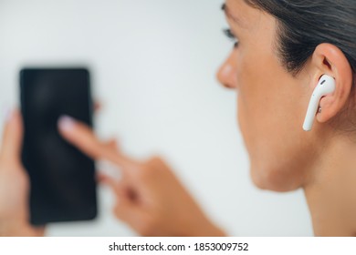 Woman Doing Audiogram Hearing Test At Home, Using Smart Phone And App.