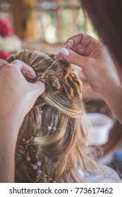 Woman Doing Bride's Hair For Wedding In French Braid Hairstyle Hairdo With Pins And Curls Back View Closeup Of Hands