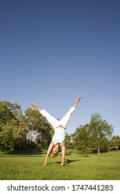 Woman Doing Cartwheel In Park