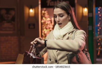 Woman Doing Christmas Shopping And Checking The Time: She Is Late