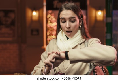 Woman Doing Christmas Shopping And Checking The Time: She Is Late