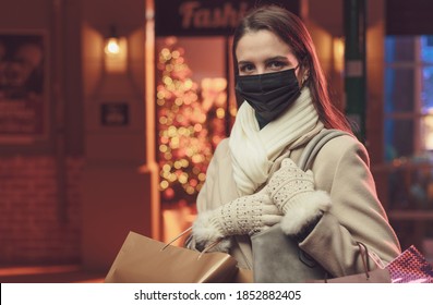 Woman Doing Christmas Shopping And Wearing A Protective Face Mask To Prevent Coronavirus Contagion