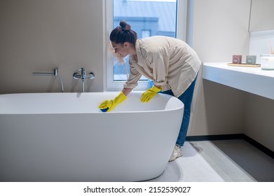 A Woman Doing Cleaning At Home And Disinfecting The Bathroom