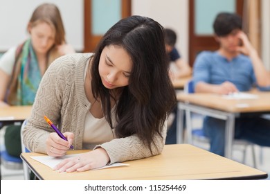 Woman Doing An Exam In Exam Hall In College