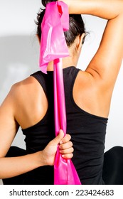 Woman Doing Exercise With Resistance Band And Stretching