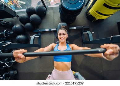 Woman Doing Exercises With Barbell On A Bench Press Training