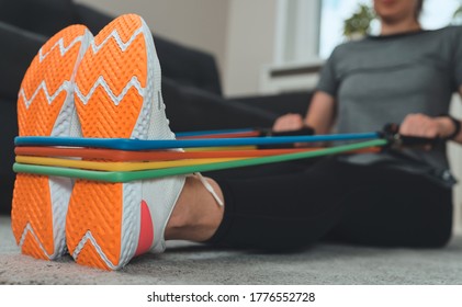 Woman doing exercises with resistance bands at home. - Shutterstock ID 1776552728