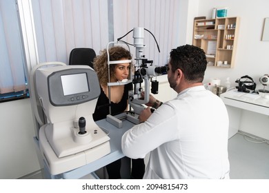 Woman Doing Eye Test With Optometrist In Medical Office