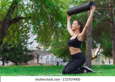 Woman Doing Foam Roller Exercise In Park