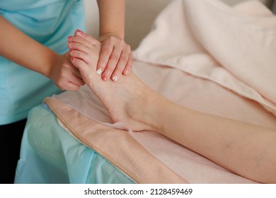 A Woman Doing A Foot Massage At An Esthetic Salon