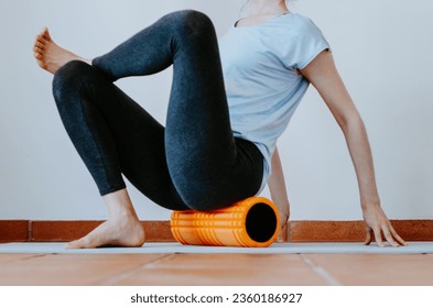 Woman doing glute myofascial release on foam roller - Powered by Shutterstock