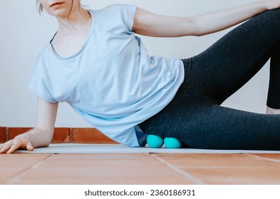 Woman doing gluteus self massage with therapy balls - Powered by Shutterstock