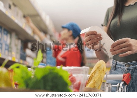 Woman doing grocery shopping and checking the receipt, hands close up
