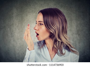Woman doing a hand breath test. - Shutterstock ID 1114736903