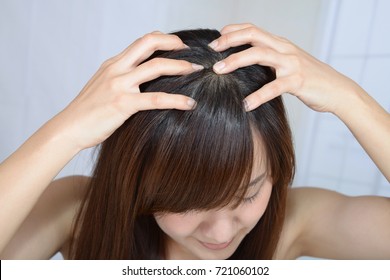 Woman doing head massage - Shutterstock ID 721060102