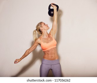 Woman doing her kettlebell workout - Powered by Shutterstock