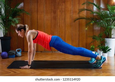 Woman Doing High-intensity Interval Training At Home. Woman Doing High Plank Exercise