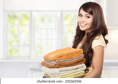 Woman Doing A Housework Holding Laundry