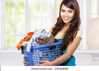 Woman Doing A Housework Holding Laundry