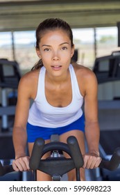 Woman Doing Interval Training On Indoor Bike.