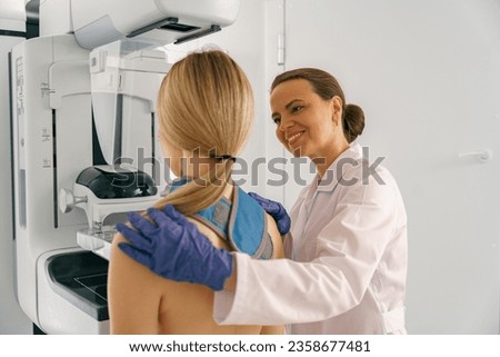 Woman doing mammogram x ray for breast cancer prevention screening at hospital [[stock_photo]] © 