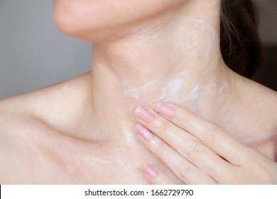 
Woman Doing Neck Massage Moisturizes Her Cream