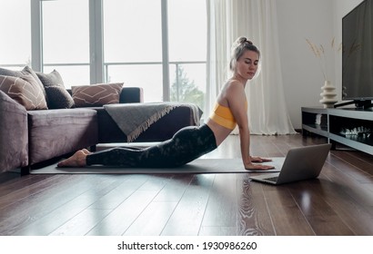 Woman Doing Online Yoga At Home. Female Trener Teaches Asana In Video Conference. Health Care, Authenticity, Sense Of Balance And Calmness.