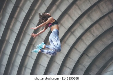 Woman Doing Parkour In The City On A Sunny Day