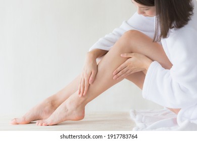 The Woman Is Doing Skin Care For Her Legs.