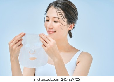 A woman doing skin care using a face pack - Powered by Shutterstock