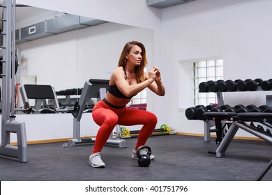 Woman Doing Squat Exercise At Gym