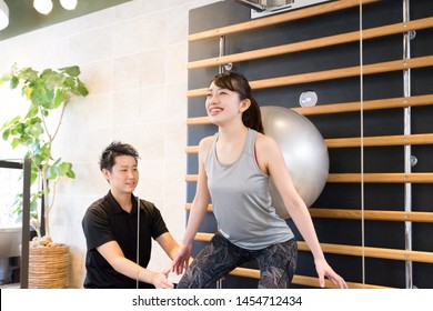 Woman Doing Squats Using A Balance Ball