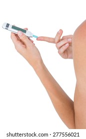 Woman Doing Test With Blood Glucose Monitor On White Background