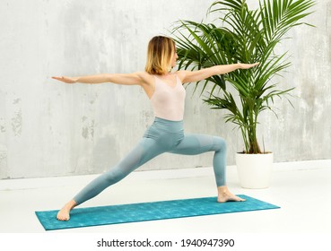 Woman Doing A Virabhadrasana II Forward Lunge Yoga Pose To Stretch And Strengthen Her Hamstring, Hip Flexor And Groin Muscles In A Health And Fitness Concept