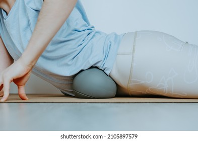 Woman Doing Visceral Self Myofascial Release On Soft Grey Ball. Concept: Self Care Practices At Home, SFMR, MyoYin