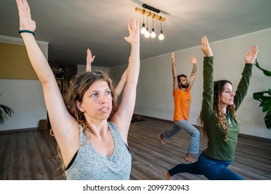 Woman Doing Warrior Pose With Group