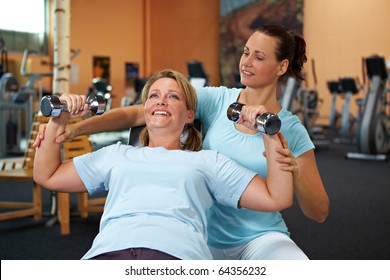 Woman doing weight training with female fitness coach - Powered by Shutterstock