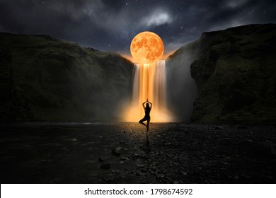 Woman doing yoga in front of a magic waterfall - Shutterstock ID 1798674592