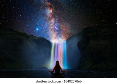 Woman doing yoga in front of a magic waterfall