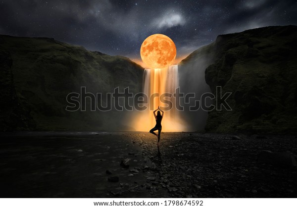 Woman doing yoga\
in front of a magic\
waterfall