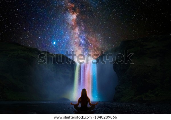 Woman doing yoga\
in front of a magic\
waterfall