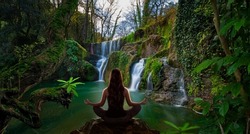 Woman Doing Yoga In Front Of A  Waterfall