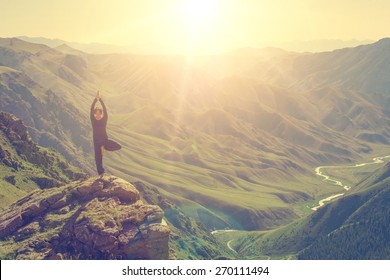 Woman doing yoga in the mountains