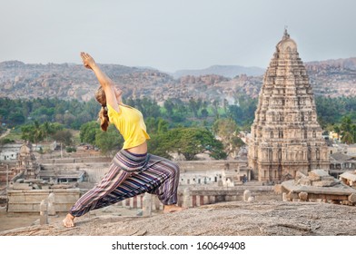 Woman Doing Yoga Near Virupaksha Temple In Hampi, Karnataka, India