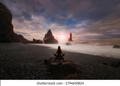 Woman Doing Yoga On Black Sand Beach